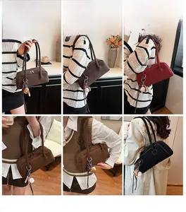 Detail view of large matte retro shoulder bags in multiple colors with hanging baseball decor