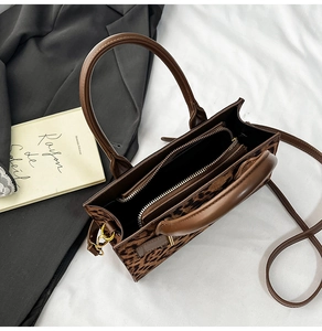 Top view of leopard print handbag showing dual zipper compartments and interior structure