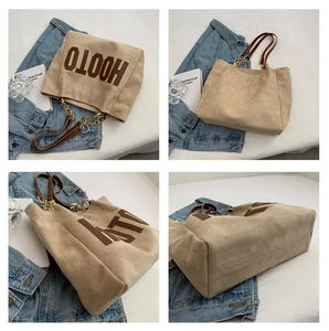 Detail view of large tote bag with premium faux suede texture and brown leather handles