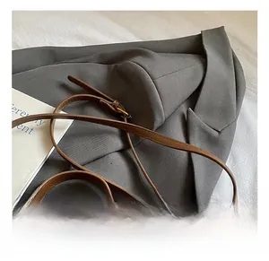 Close-up of adjustable strap and leopard print detail on retro brown crossbody bag
