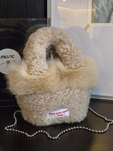 Beige faux fur tote bag with metal bead chain strap and keep your spirit free label