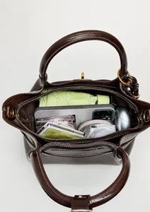 Deep brown bucket bag interior showing spacious capacity with everyday essentials