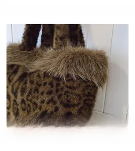 Detailed macro view showing soft leopard print faux fur texture of the plush tote bag