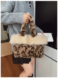 Detail of leopard print faux fur tote bag featuring soft beige plush trim and thick texture