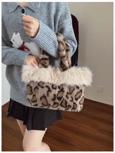 Close-up of leopard print faux fur handbag with white plush trim worn by a model
