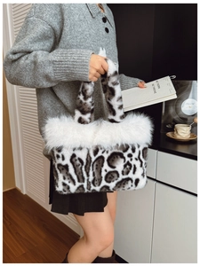 Detailed close-up of leopard print faux fur tote bag with fluffy white plush trim handle