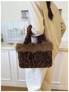 Detailed back view of a plush leopard print faux fur tote bag with fluffy trim handle