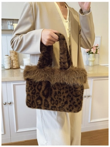 Detail view of leopard print faux fur tote bag with fluffy plush trim for winter style
