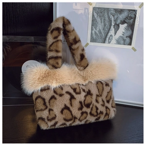 Close-up of leopard print faux fur texture and beige plush trim on luxury tote bag