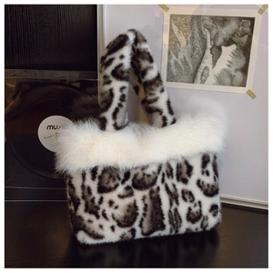 Close-up of leopard print faux fur handbag featuring plush white faux fur trim and texture