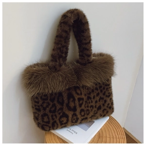 Detail view of leopard print faux fur tote bag with soft plush texture and wide top handle