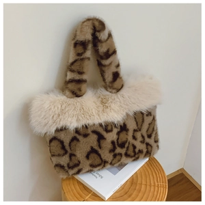 Detailed view of plush leopard print faux fur tote bag on a wooden stool setup
