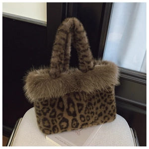 Close-up of leopard print faux fur handbag with fluffy plush handle on a white chair