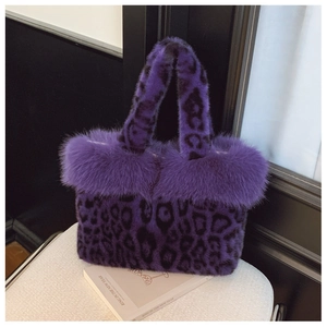 Detail of purple leopard faux fur tote with plush texture and long hair trim