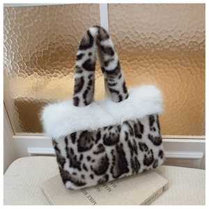 Detail of faux fur leopard print tote bag with fluffy white trim and sturdy handles