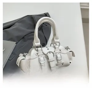 Detail of white leather motorcycle bag with silver buckles and stud decorations
