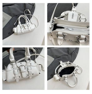 Macro view of white leather crossbody bag with silver buckles and punk rivets details