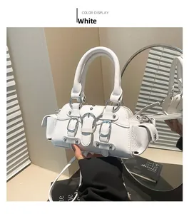 Detailed close-up of white lychee grain leather bag with silver metal buckles and rings