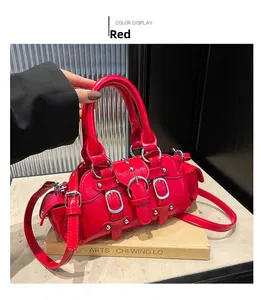 Detailed macro view of vibrant red glossy leather bag with silver metallic buckles