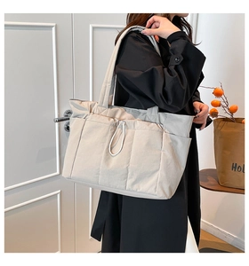 Close-up of lightweight tote bag with drawstring detail and multi-pocket structure