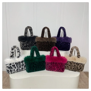Detail view of seven colorful leopard print faux fur handbags on a white tiered stand