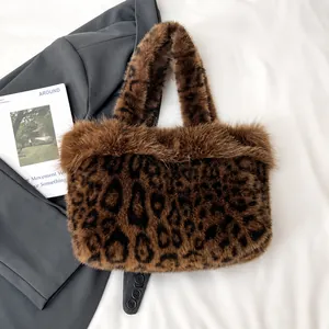 Close-up detail of plush leopard print tote bag texture with soft faux fur and brown handle