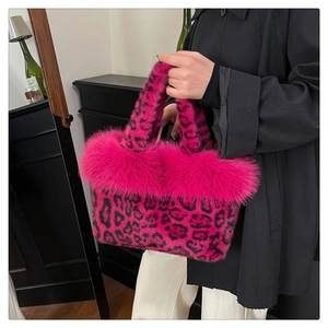 Detail of pink leopard print plush handbag with soft faux fur trim and dual handles