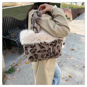 Detail view of the plush leopard print tote bag featuring a fluffy white faux fur trim