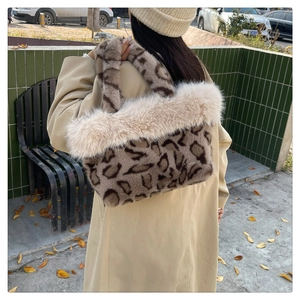 Detail shot of a large leopard print faux fur tote bag with plush beige trim on the edge