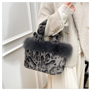 Close-up of grey leopard faux fur tote bag with plush trim and soft textured handles