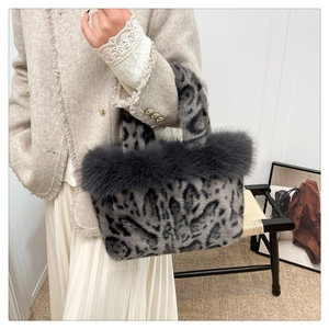 Detailed view of leopard print faux fur handbag with fluffy grey trim and twin handles