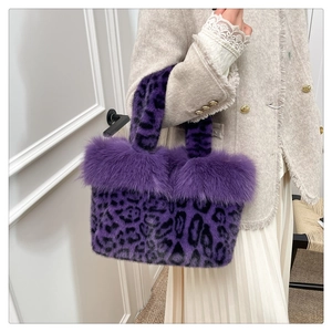 Detailed close-up of fluffy purple leopard print faux fur handbag with plush handle