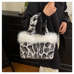 Detail of leopard print faux fur handbag featuring fluffy white plush trim on top