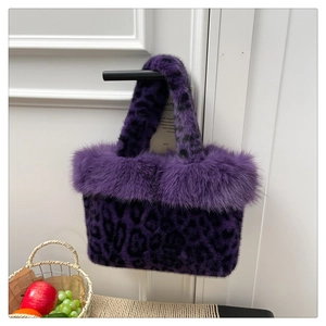 Detail shot of purple leopard print faux fur tote bag hanging on a white door