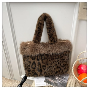 Detail of faux fur leopard print handbag with plush trim against a lifestyle backdrop