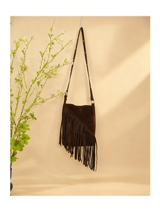 Detailed close-up of dark brown faux suede crossbody bag with bohemian style fringe