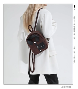 Detailed close-up of brown suede mini backpack featuring a unique shirt style design
