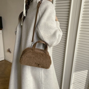 Detailed texture of brown plush lamb wool crossbody bag with leather handles