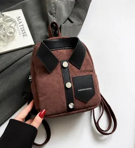 Detailed view of a brown suede backpack with creative shirt collar design and black buttons