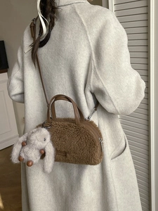 Brown faux fur plush handbag with leather strap and white rabbit charm for winter fashion