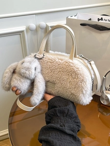 Chic beige faux shearling crossbody bag with cute rabbit charm and leather straps