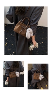 Detail of vintage brown leopard print bucket bag with plush rabbit charm and crossbody strap