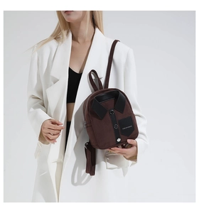 Detail of a brown shirt-shaped mini backpack with black collar and button design