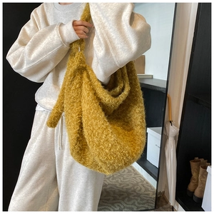 Detail view of mustard yellow wool hobo bag showing fuzzy texture and large capacity