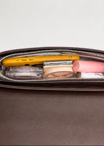 Interior storage view of dark brown leather underarm bag with zipper and large capacity