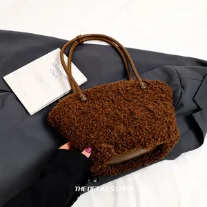 Detail showing plush brown faux fur texture and contrast leather handle on the tote bag