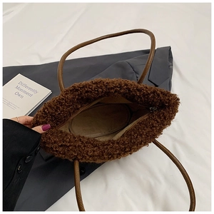 Macro view of plush brown teddy fleece tote bag with smooth zipper and interior lining