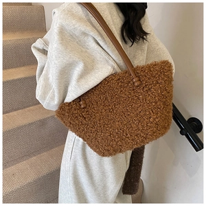 Close-up of deep brown plush faux fur tote bag with slim leather shoulder straps
