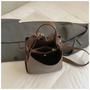 Detailed interior of vintage brown crocodile embossed bucket bag with zipper compartment