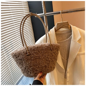 Detail of soft brown faux shearling tote bag with long handles and fluffy texture